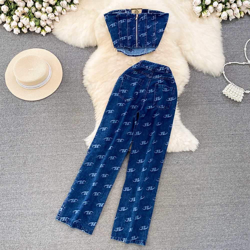 Blue patterned pants with a matching top on a textured surface with decorative elements.