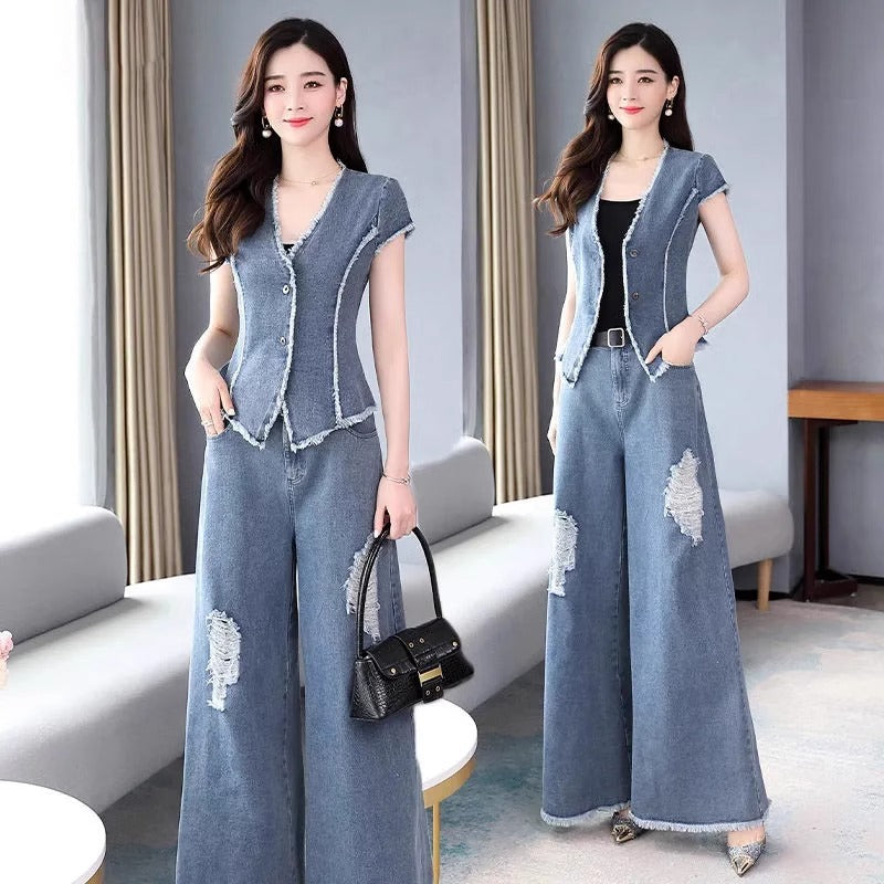 Woman wearing a denim outfit with a vest and wide-leg pants in a modern living room.