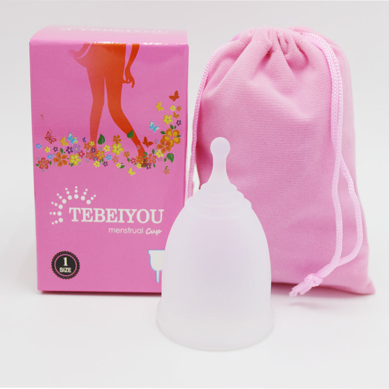Menstrual cup with pink packaging and drawstring bag on a white background