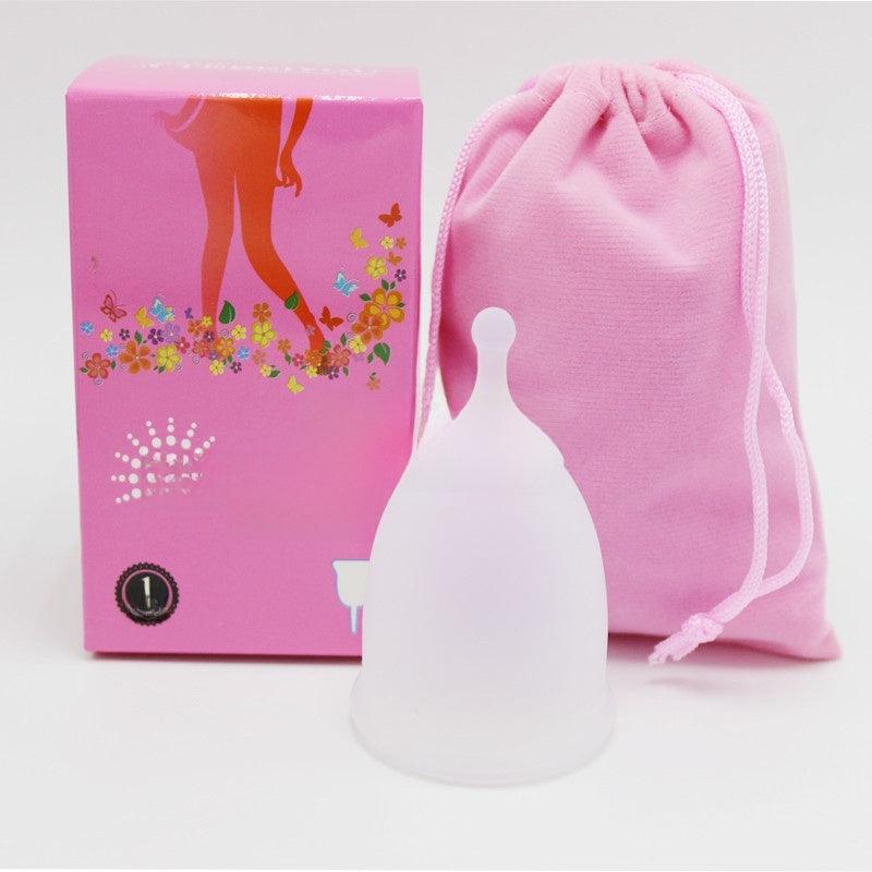 Silicone cup with pink packaging and drawstring bag on a white background