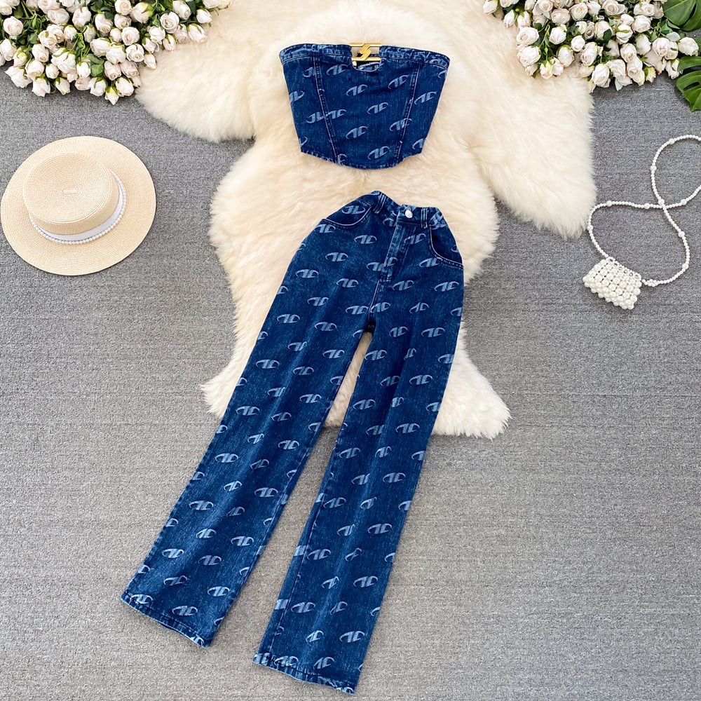 Blue patterned pants with a matching hat on a textured surface with flowers and a hat in the background.