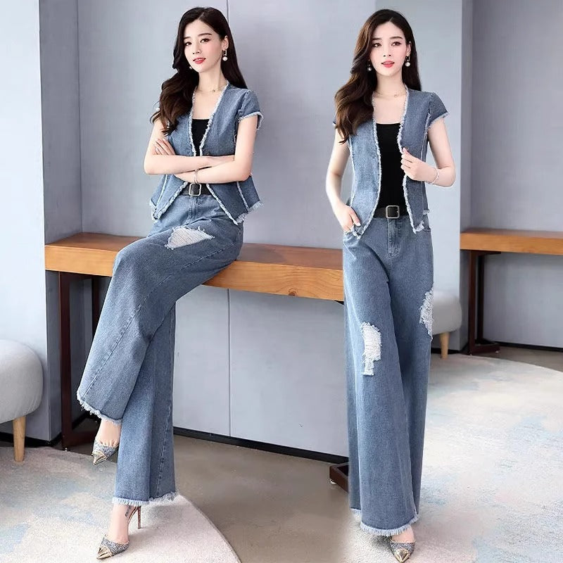 Woman wearing a denim outfit sitting on a wooden bench.